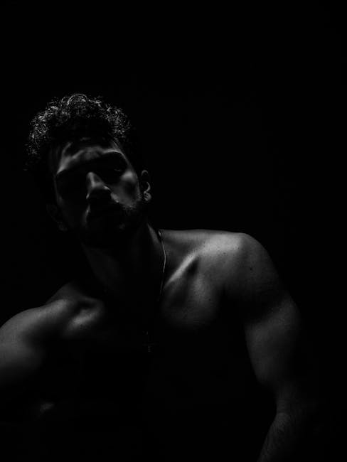 Dramatic black and white male portrait with moody lighting